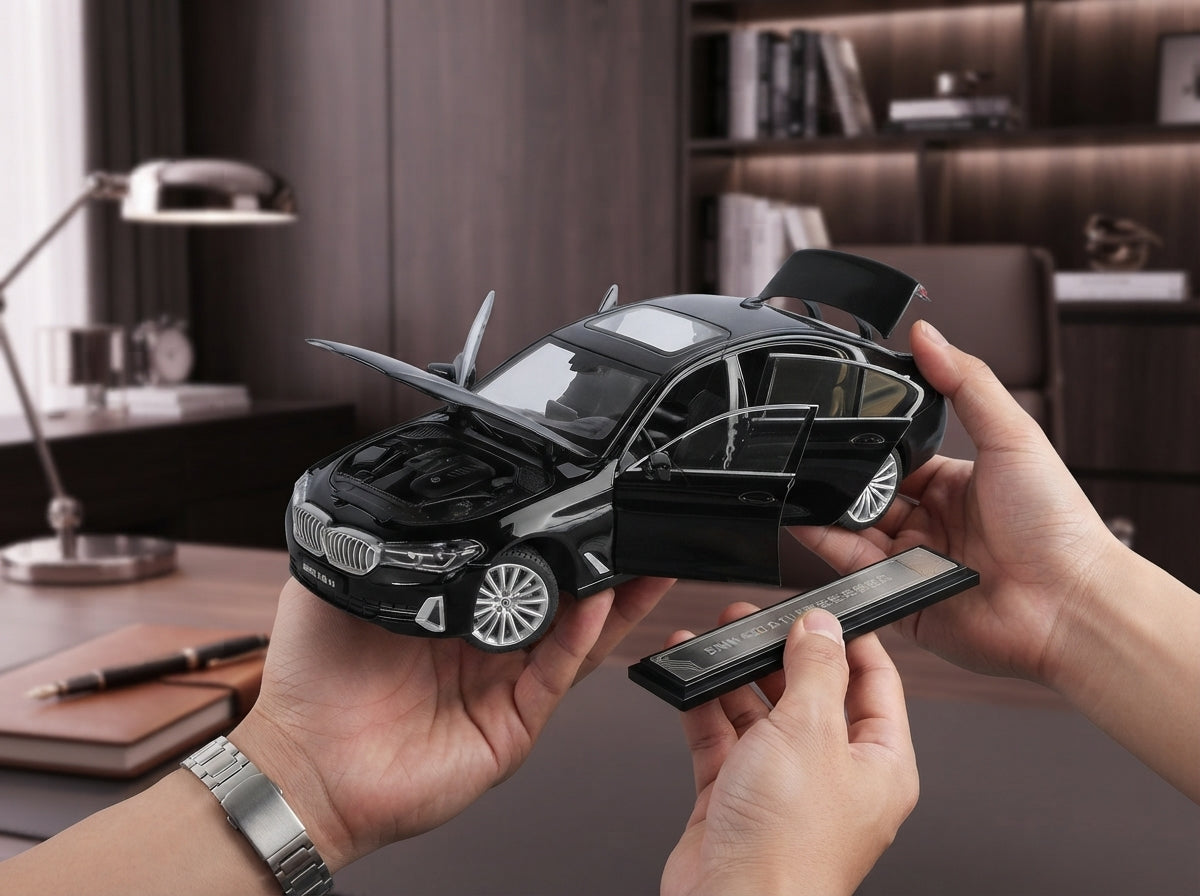 Hands holding a detailed black diecast alloy car model in a modern room with soft rose and white blurred background lighting.