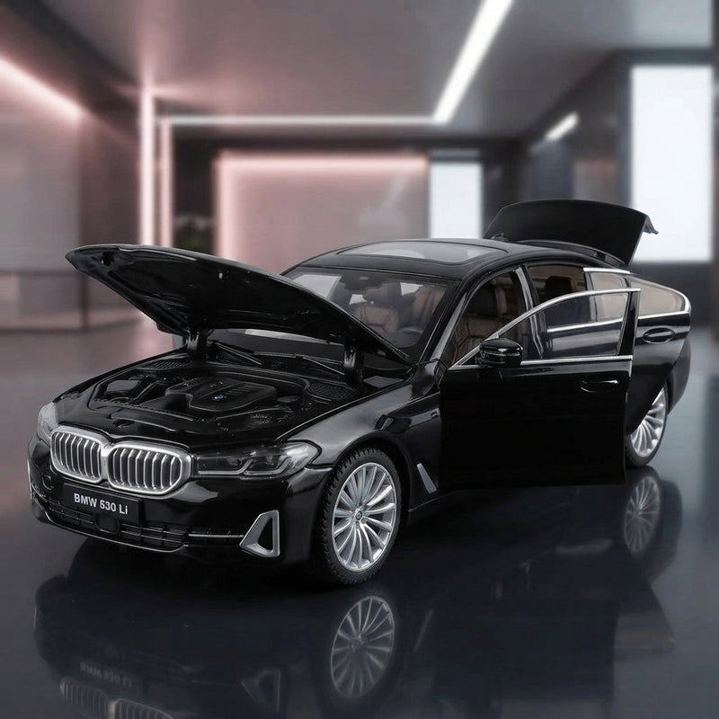 A close-up of a detailed Black Mamba diecast alloy car on a reflective surface, showcasing its metallic finish and craftsmans