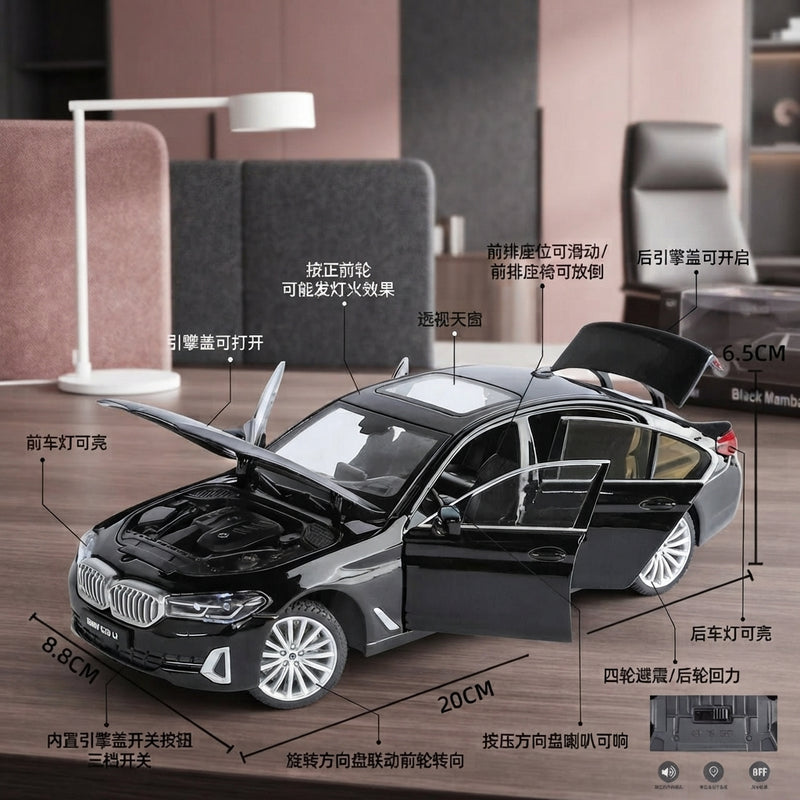 A detailed close-up of a Black Mamba diecast car model sitting on a desk, showcasing precise mechanical craftsmanship.